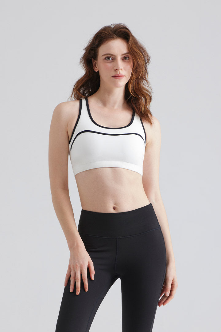 Saltum Woman wearing a white sports bra and black leggings