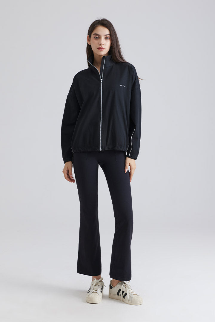 Woman black jacket and pants with white sneakers