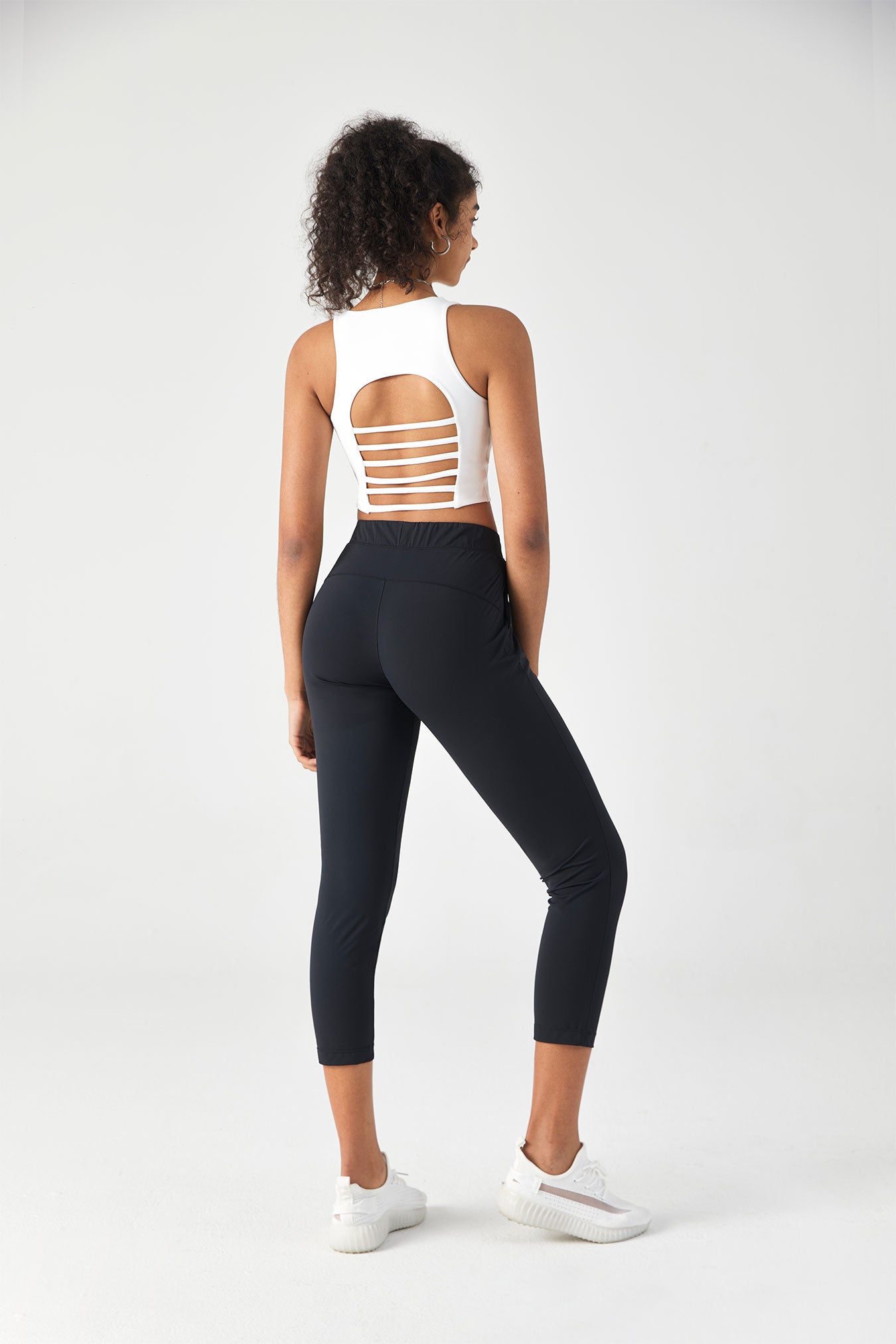 white crop top with cut-out design and black leggings