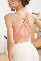 Woman brick red sports bra back Criss Cross Sports Bra