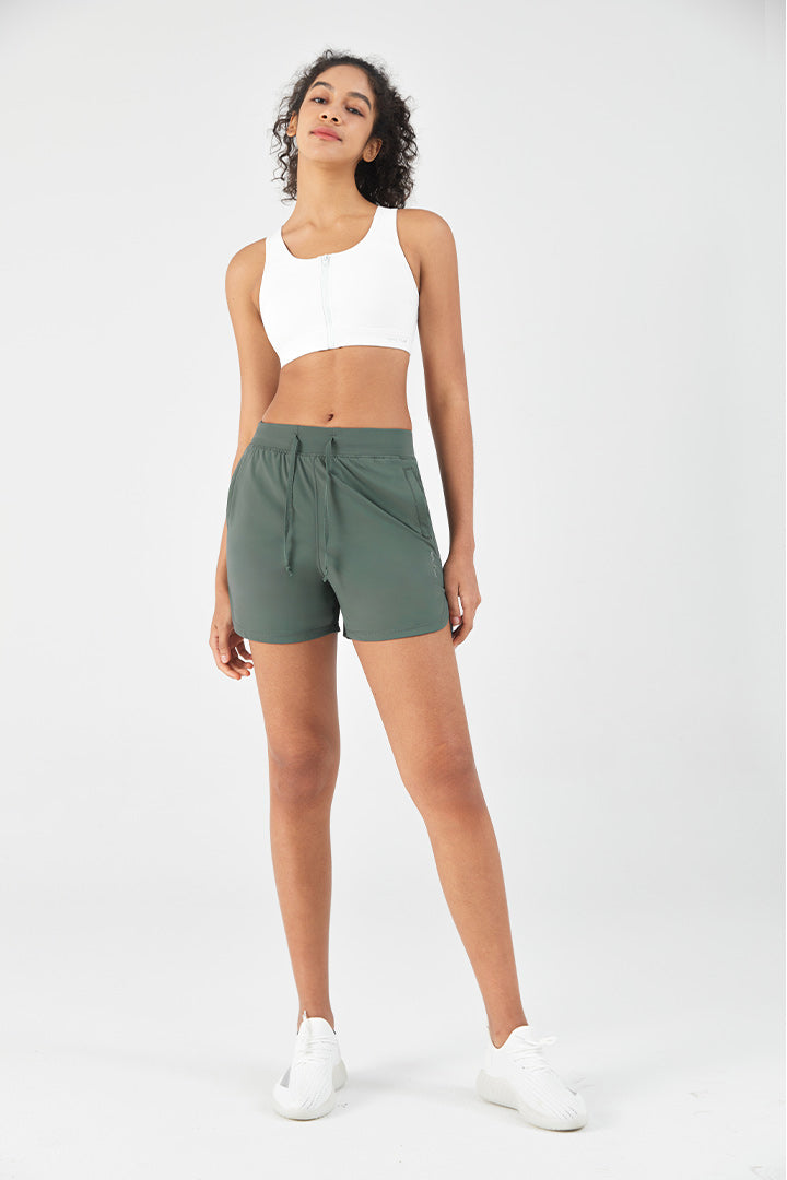 hot girl walk outfit with a white sports bra and lightweight running shorts