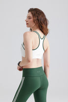 Woman white High Support sports bra and green leggings