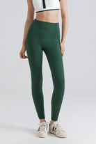 Person wearing green leggings and a white crop top 