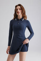 Woman navy blue golf dress with white trim and shorts