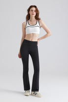 Woman wearing a white sports bra and black leggings Sets