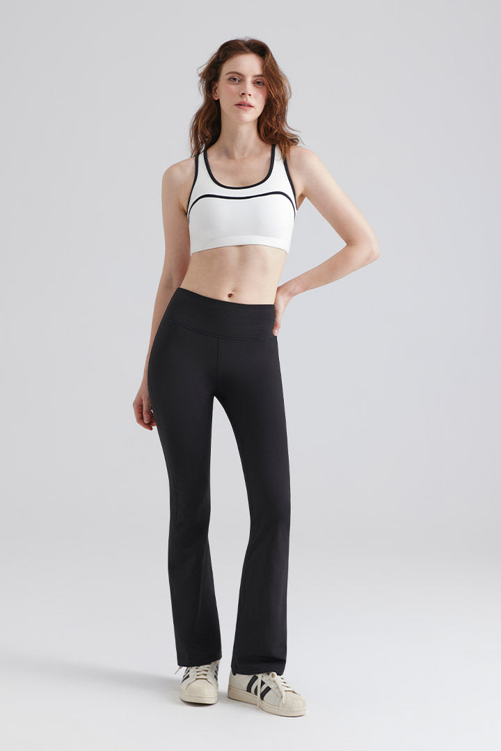 Woman wearing a white sports bra and black leggings Sets