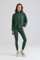 Woman green tracksuit with white stripes for sports runnng