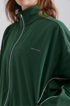 Green jacket and leggings with a brand logo 