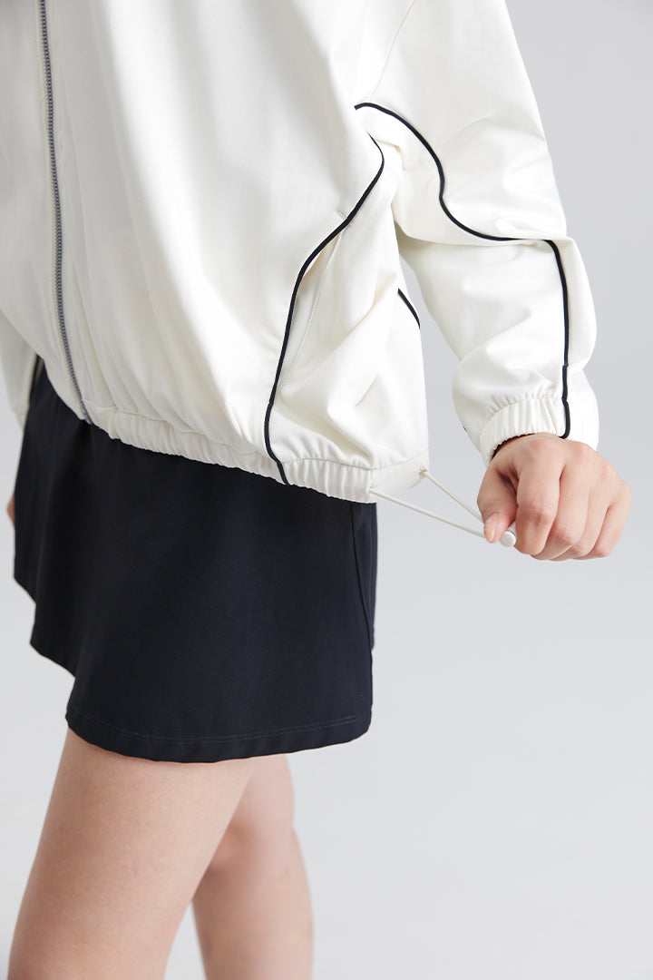 women white jacket with black trim and black shorts