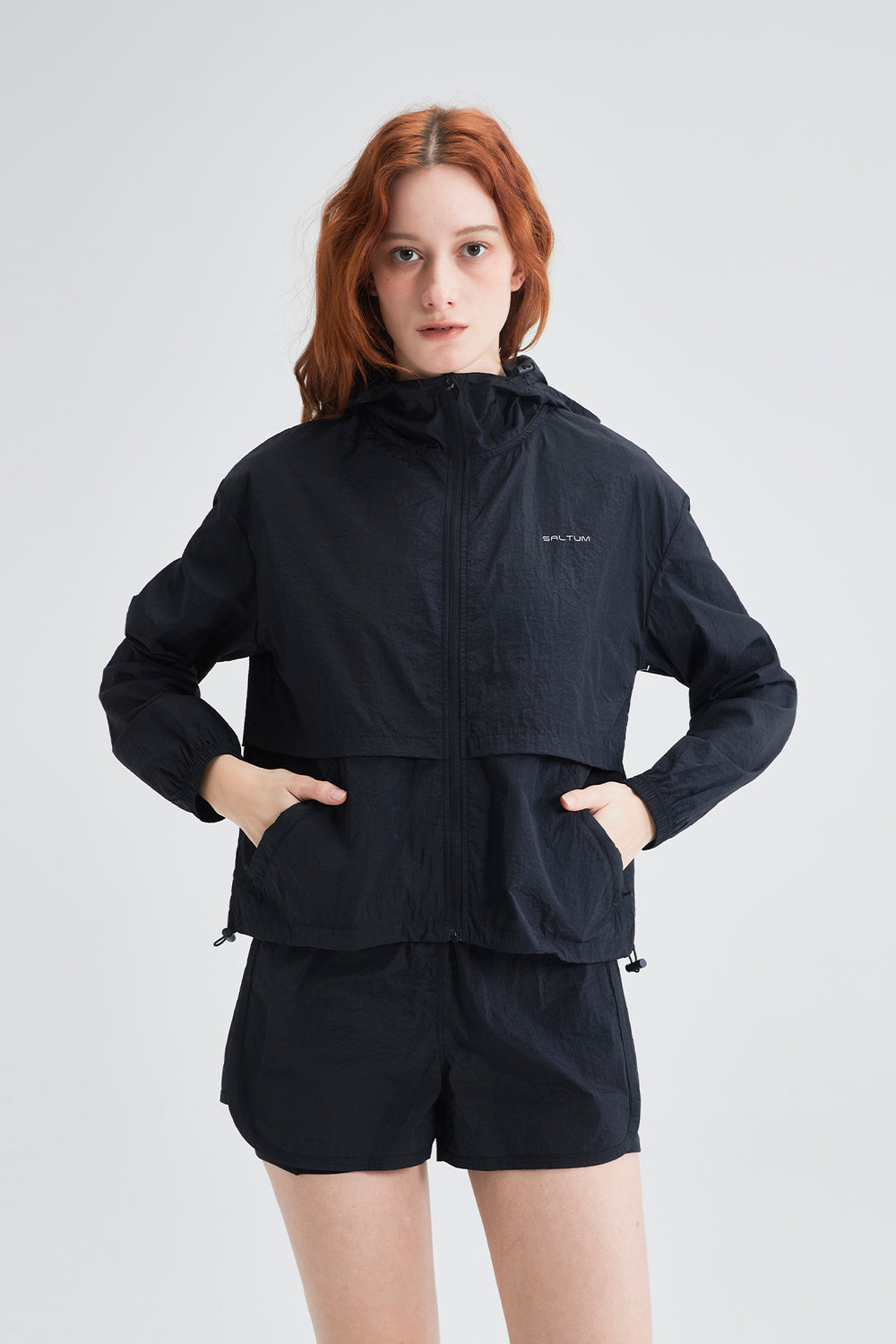 lightweight black sun jacket styled with shorts for a summer walking outfit