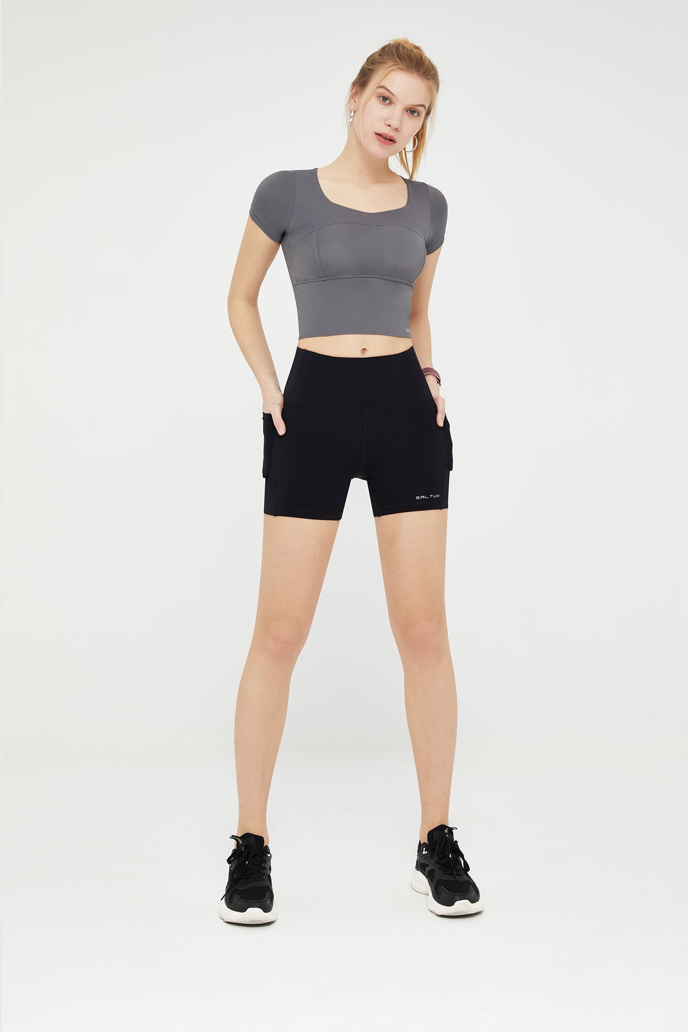 Woman gray crop top and black shorts stretchy biker shorts Running Shorts