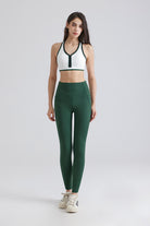 Woman white sports bra and green leggings and bra