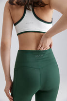 women white sports bra and green leggings for yoga workout