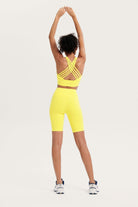 womens yellow sports outfit with a strappy top and high-waisted shorts