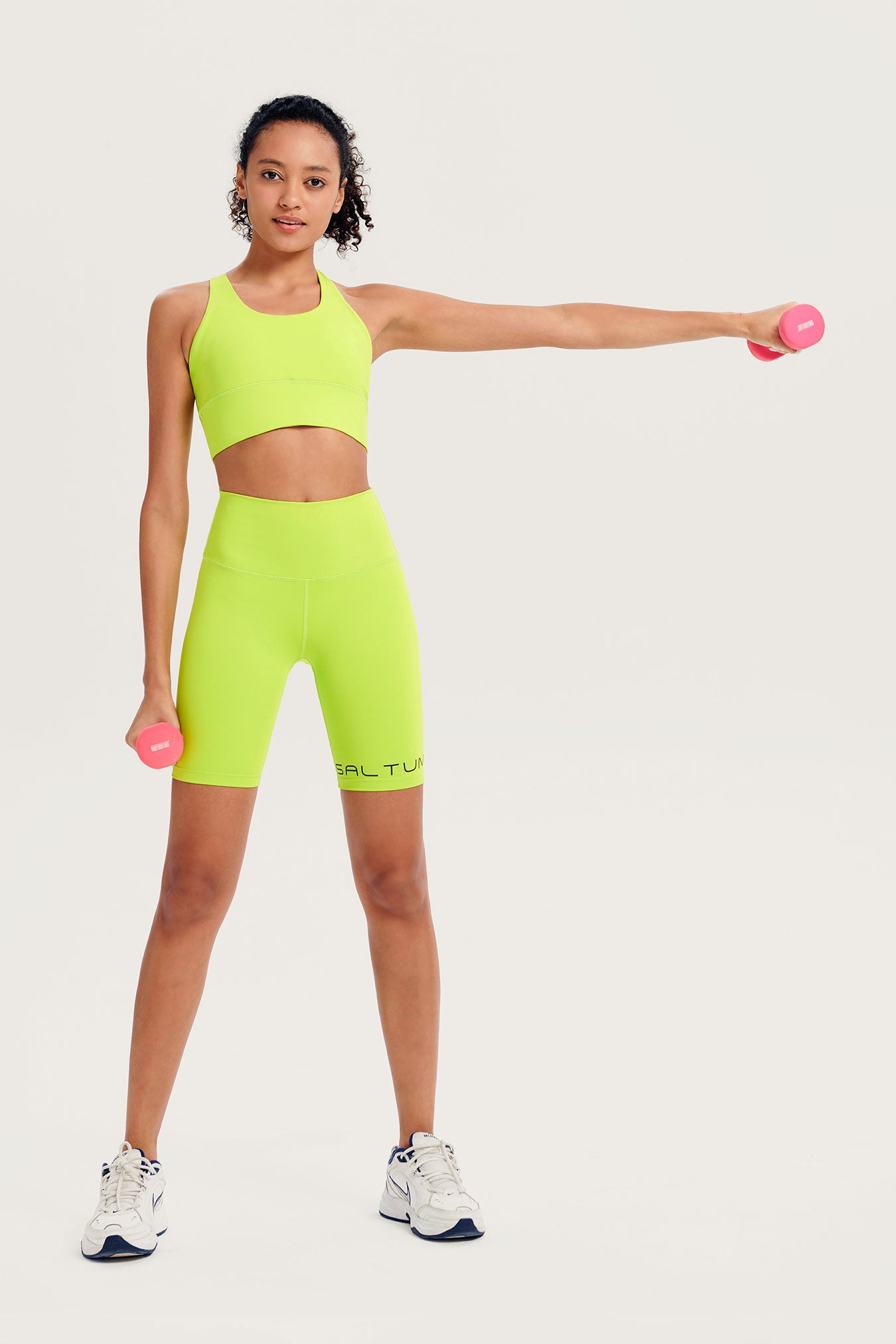 Saltum light green athletic outfit with pink dumbbells