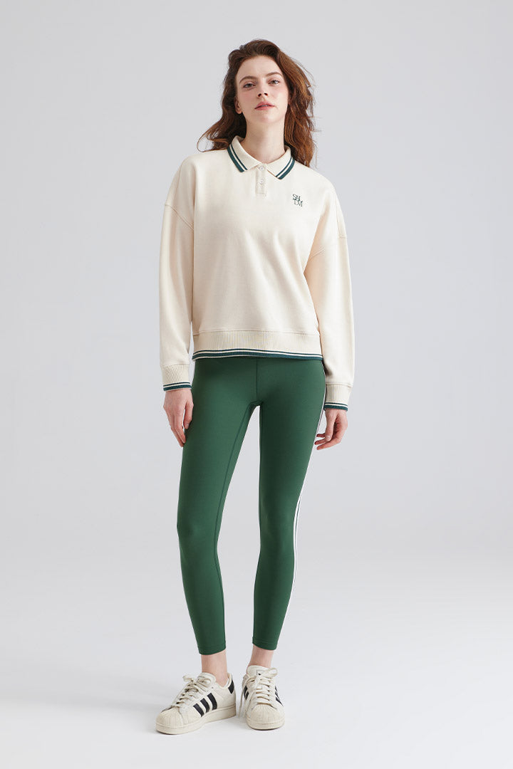 Woman polo sweater with green accents and green leggings